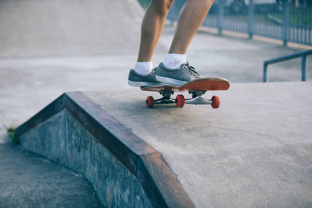 Cropped image of skateboarder skateboarding on skatepark ramp - Photo, Image