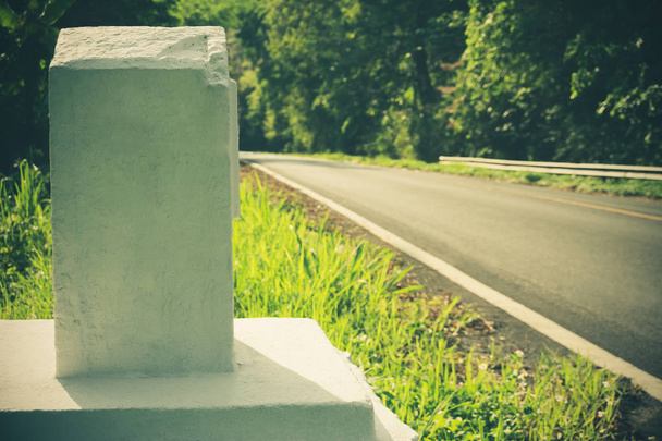 Le marqueur kilométrique est fait de ciment sur le bord de la route. Le concept de voyage touristique
. - Photo, image