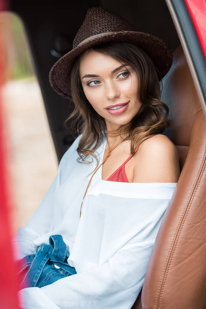 attractive girl sitting in car during road trip - Photo, Image