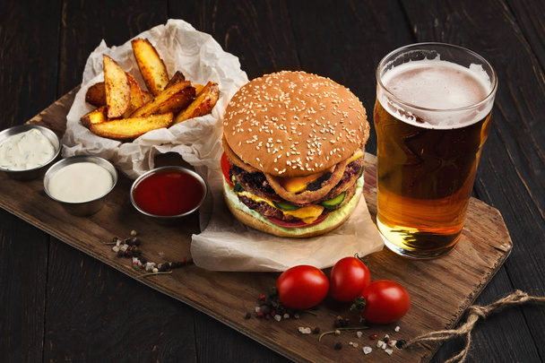 Fast food restaurant dish. Hamburger and fries wedges - Fotó, kép