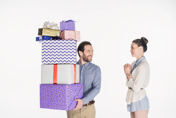portrait of man couple pile of wrapped gifts and wife standing near by isolated on white - Photo, Image