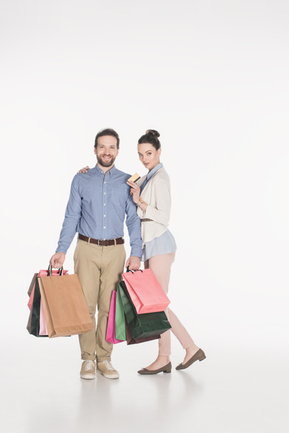 couple with shopping bags and credit card isolated on white - Photo, Image
