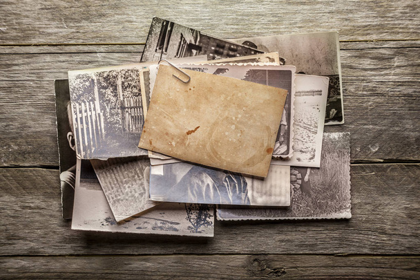 stack of vintage photos on wooden background - 写真・画像