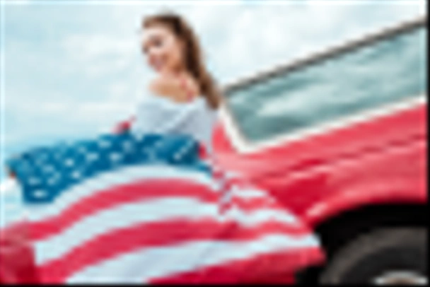 attractive girl with american flag standing near red car - Photo, Image