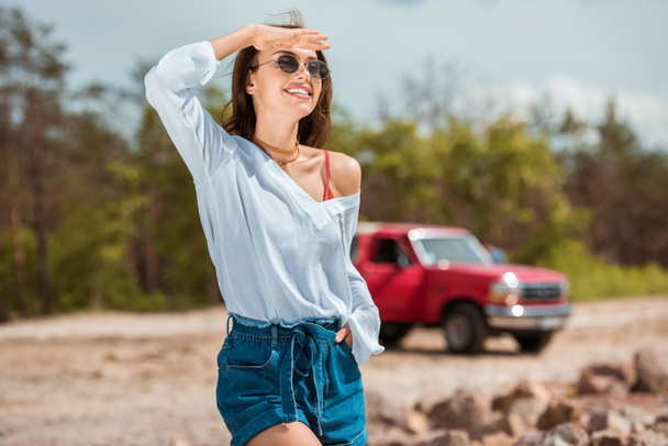 cheerful young woman in sunglasses on road trip - Фото, зображення