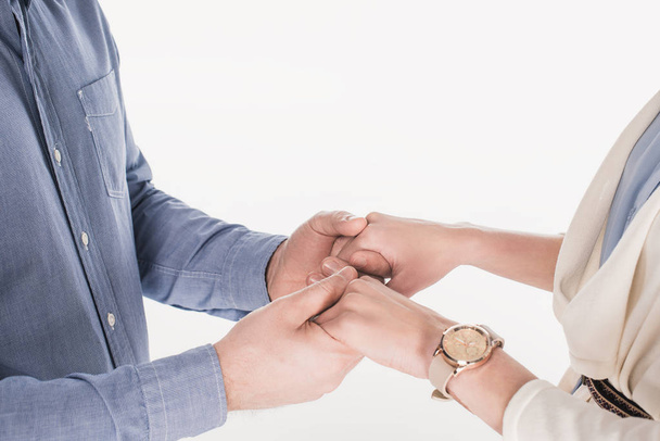 cropped shot of wife and husband holding hands together isolated on white - Fotó, kép
