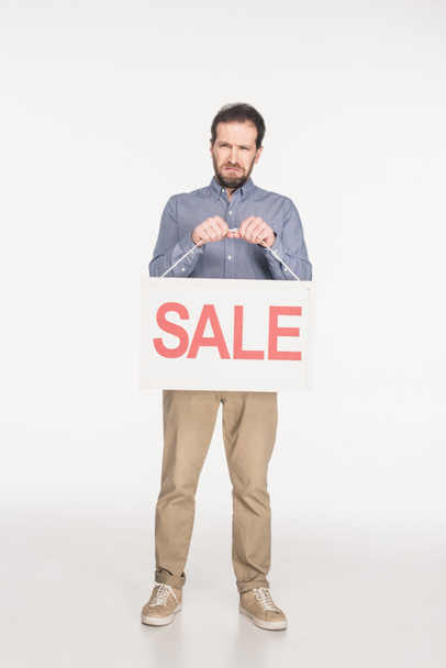 upset man with sale card isolated on white - Photo, Image