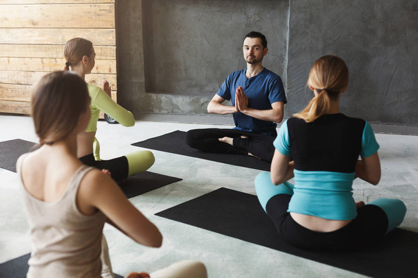Group with yoga instructor in fitness club - Фото, зображення