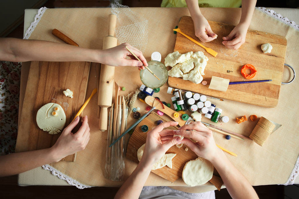 Women and child girl make handmade dough crafts - Foto, imagen