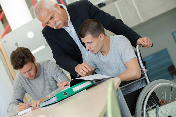student in wheelchair working in assitance class - Fotografie, Obrázek