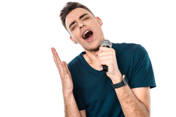 Young handsome guy singing karaoke expressively - Photo, Image