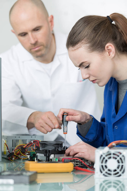 female apprentice learning to use a multimeter - Photo, image