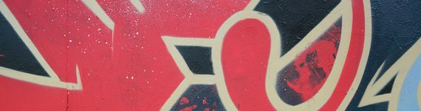 Street art. Abstract background image of a fragment of a colored graffiti painting in red tones. - Foto, imagen