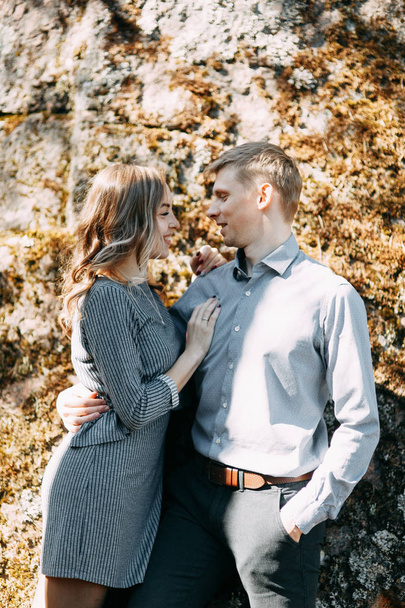 Pre-wedding photo shoot in the forest in nature, in the form of walking and traveling. Beauty of the North and Russia. Loving people and beautiful scenery. They laugh, sit and smile. Beautiful couple - Zdjęcie, obraz