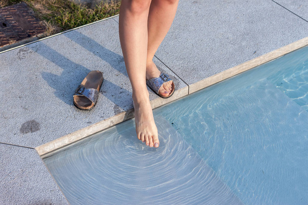 female leg touching water - Foto, Bild