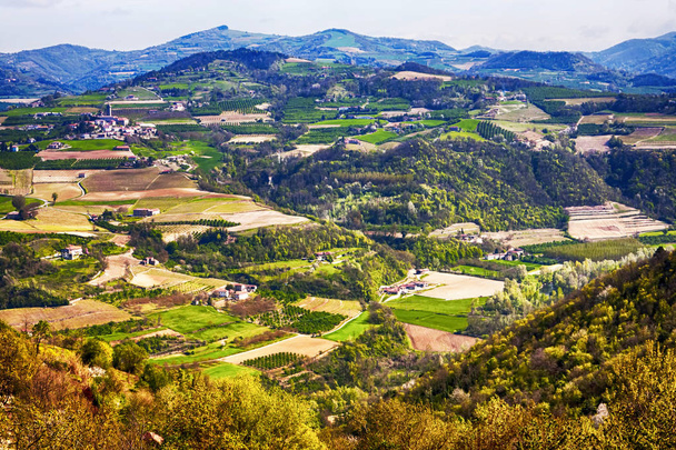 Countryside panorama with farms and houses and cultivated fields - Photo, Image