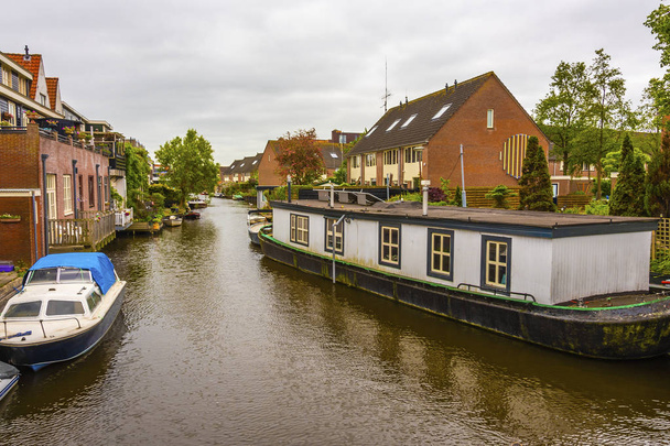 canal and different types of housing surrounding it in a suburb of the city of alkmaar netherlands holland - Photo, Image