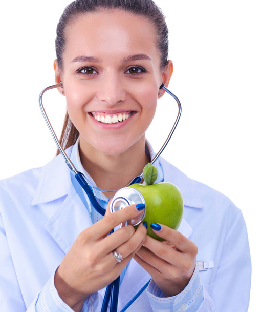 Medical doctor woman examining apple with stethoscope. Woman doctors - Fotoğraf, Görsel