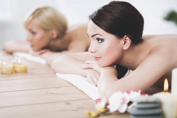 Two young beautiful women relaxing and enjoying at the spa. Two young beautiful women relaxing - Photo, Image
