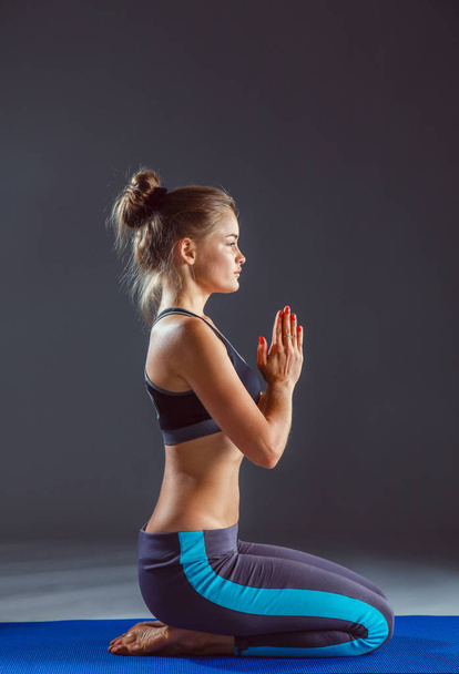 Portrait of sport girl doing yoga stretching exercise . yoga - Zdjęcie, obraz