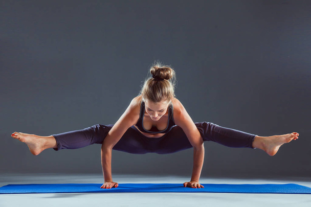Portrait of sport girl doing yoga stretching exercise . yoga - Фото, изображение