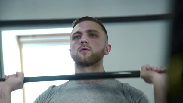 Portrait of a strong brutal man who lifts barbell. - Video