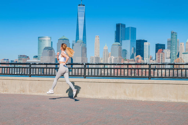 Healthy lifestyle. Woman is running in New York. Fitness sports runner is jogging in  the city - Fotó, kép