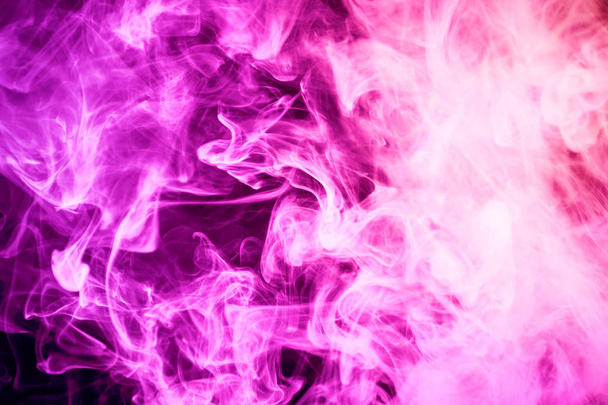 Thick pink smoke on a black isolated background. Background from the smoke of vap - Photo, Image