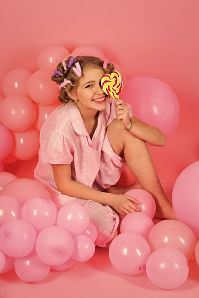 Little girl with candy lollipop. - 写真・画像
