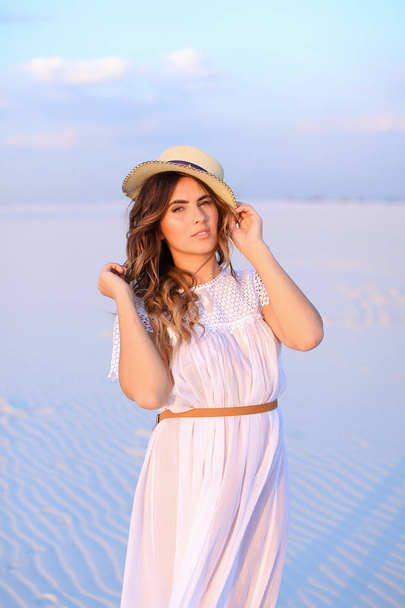 Young european female person wearing white dress and hat standin - Foto, Imagem