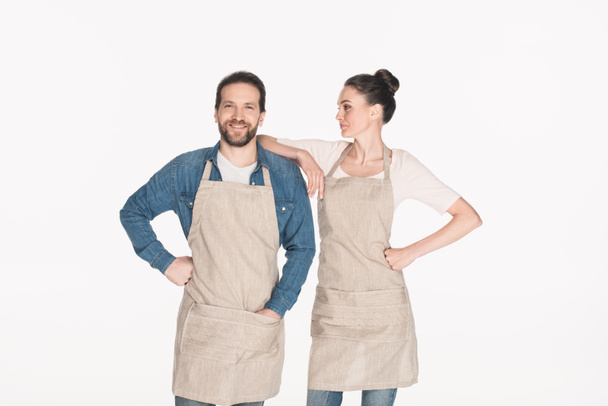 portrait of man and woman in aprons isolated on white - Valokuva, kuva