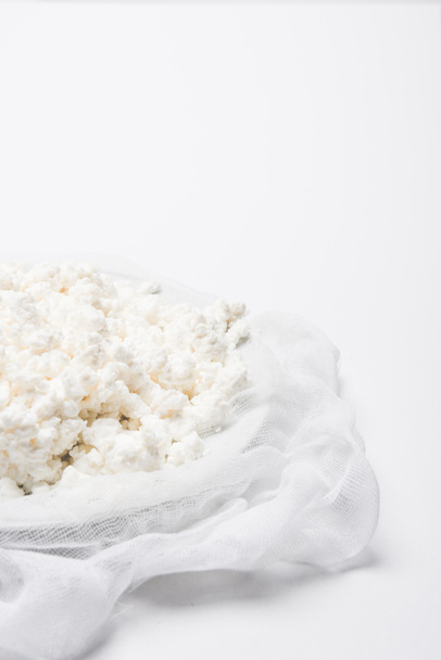 close-up shot of cottage cheese on cheesecloth on white surface - Φωτογραφία, εικόνα