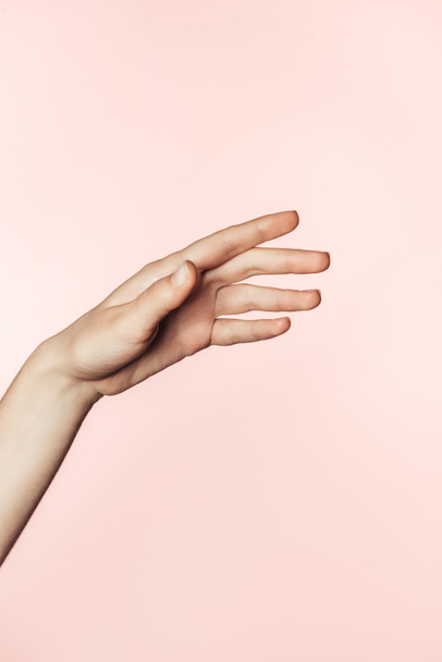 cropped image of woman gesturing by hand isolated on pink background  - Фото, изображение