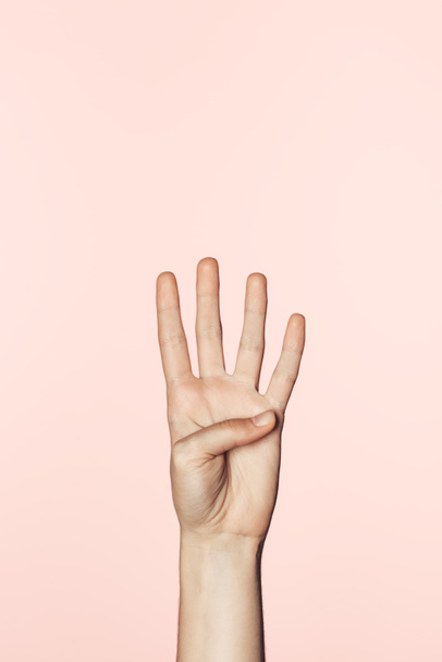 cropped shot of woman counting from one to four by hand isolated on pink background - Фото, изображение