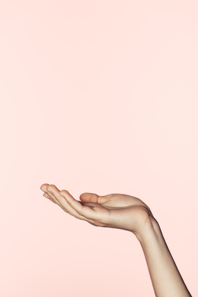 partial view of woman gesturing by hand isolated on pink background  - 写真・画像