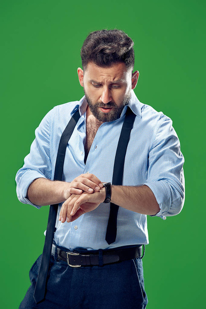 Handsome businessman checking his wrist-watch Isolated on white background - Φωτογραφία, εικόνα