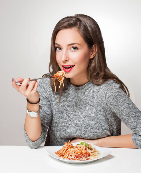 Gorgeous young brunette woman having Italian food. - Fotografie, Obrázek