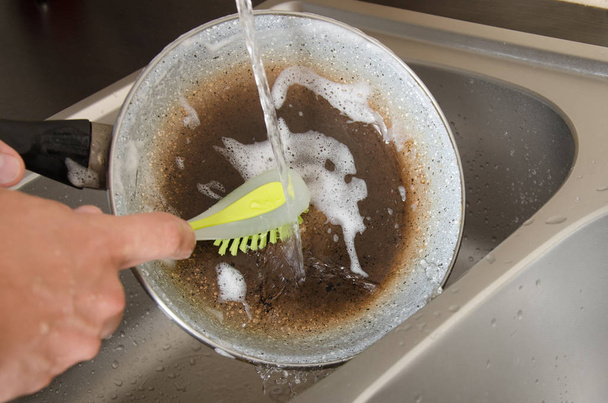 The dishwasher washes the dishes with a detergent - Valokuva, kuva