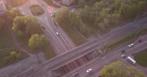 Top view round road junction in the smoll city in sunset. active city traffic cars. Aerial flight. 4K - Footage, Video