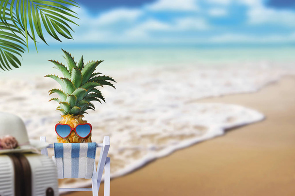 Pineapple on chair at the beach with copy space summer concept - Photo, Image