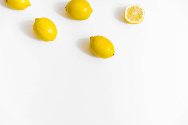 A few lemons on white background. Flat lay, top view. Copy space, header for blog  - 写真・画像
