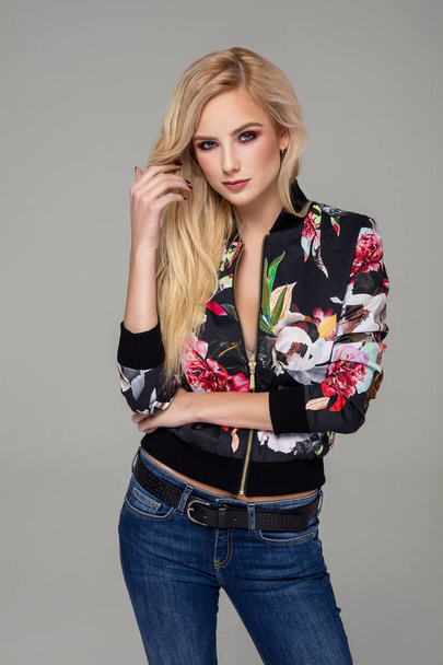 Beautiful blond model wear bomber jacket in flowers - 写真・画像
