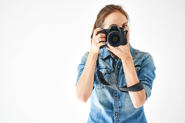 Portrait of a girl photographer on a white background - Zdjęcie, obraz