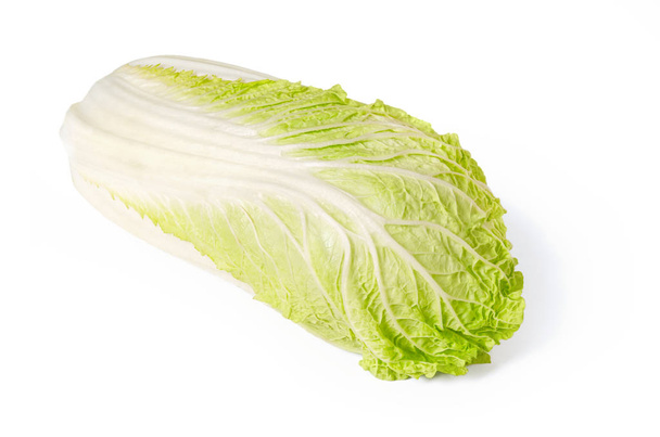 Napa cabbage front view on white background. Chinese cabbage, also called nappa and wombok. Raw, fresh, uncooked and green vegetable. Brassica rapa Perkinensis Group. Macro food photo close up. - Fotografie, Obrázek