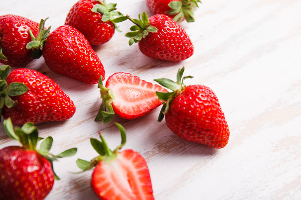 Ripe fresh strawberry on white desk. Fruits close up - Фото, изображение
