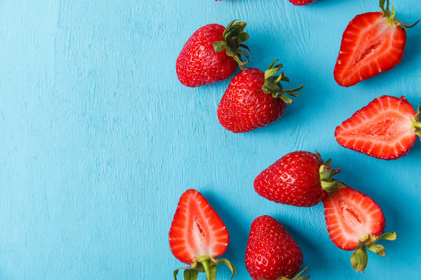 Ripe fresh strawberry on blue background. Fruits close up - Photo, Image