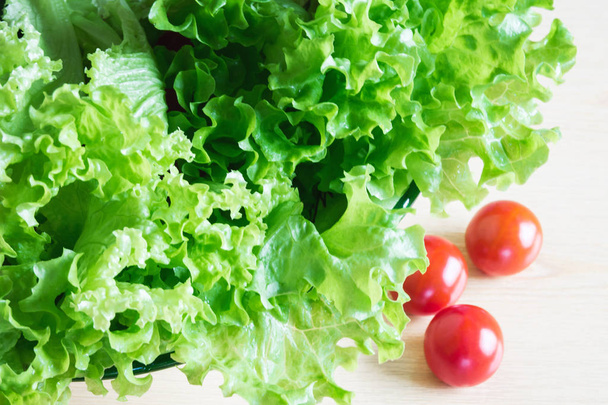The concept of healthy eating. Background with vegetables. Green salad and tomatoes - Photo, Image