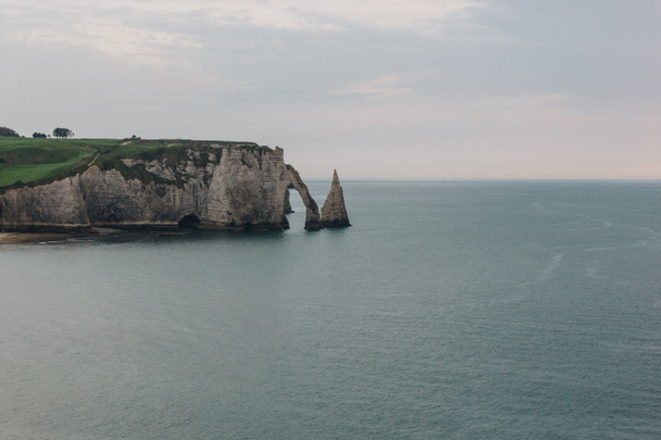beautiful rocky cliff on cloudy day at Etretat, France - Photo, Image