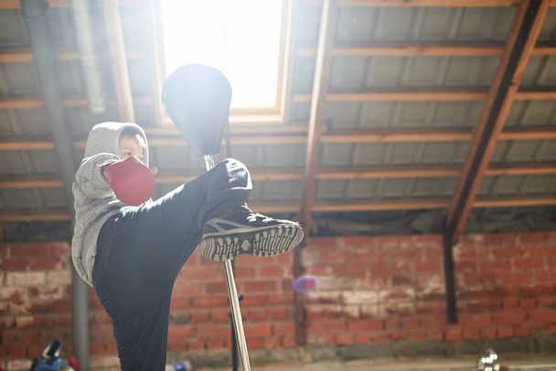 little boy wearing boxing gloves fighting in gym - Photo, Image