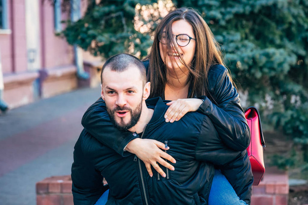 Smiling couple in love outdoors.Young happy couple hugging on the city street. - Fotografie, Obrázek